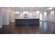 Open-concept kitchen featuring a large island, stainless steel appliances, and hardwood floors at 14 Berkten Ct, Hiram, GA 30141