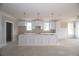 Spacious kitchen with white cabinets, island, and natural light at 14 Berkten Ct, Hiram, GA 30141