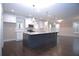 Spacious kitchen featuring a large center island, stainless appliances, and pendant lighting at 14 Berkten Ct, Hiram, GA 30141