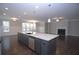 Open concept kitchen with island, stainless appliances, and adjacent living room with fireplace at 14 Berkten Ct, Hiram, GA 30141