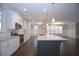 Open kitchen with white cabinets, stainless steel appliances, island, and hardwood floors at 14 Berkten Ct, Hiram, GA 30141