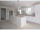 Open kitchen area features white cabinets, a large island, pendant lighting and lots of natural light at 14 Berkten Ct, Hiram, GA 30141