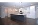 Modern kitchen with a center island, stainless steel appliances, and white cabinetry at 14 Berkten Ct, Hiram, GA 30141
