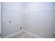 Laundry room with white wire shelving, tile flooring, and utility connections, providing a functional space at 14 Berkten Ct, Hiram, GA 30141