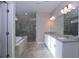 Main bathroom showcases a double vanity, soaking tub, and glass-enclosed shower, blending style and function at 14 Berkten Ct, Hiram, GA 30141