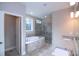 Main bathroom featuring double vanity sinks, a glass shower, and a separate tub for a spa-like experience at 14 Berkten Ct, Hiram, GA 30141