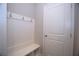Mudroom featuring a built-in bench, coat hooks, and a white door, providing a convenient entryway storage solution at 14 Berkten Ct, Hiram, GA 30141
