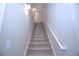 Carpeted staircase with a white handrail, offering a clear view of the treads at 14 Berkten Ct, Hiram, GA 30141