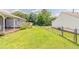 Spacious backyard with green grass and a chain link fence at 3217 Canterbury Trl, Rex, GA 30273