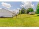 Fenced backyard with green lawn, shed, and neighboring house at 3217 Canterbury Trl, Rex, GA 30273