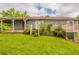 Beautiful home with a deck and a backyard with mature trees and landscaping, and open green space at 3217 Canterbury Trl, Rex, GA 30273