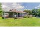 Backyard view of house with covered porch, wooden deck, and lawn at 3217 Canterbury Trl, Rex, GA 30273