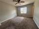 A bedroom showcasing neutral walls, floors and a ceiling fan with a large window providing natural light at 3217 Canterbury Trl, Rex, GA 30273