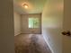 A bedroom showcasing neutral walls, floors and a ceiling fan with a large window providing natural light at 3217 Canterbury Trl, Rex, GA 30273