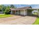 Single-story home with large driveway and covered parking area at 3217 Canterbury Trl, Rex, GA 30273