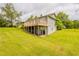 View of the home featuring a large deck and a well-maintained lawn at 3217 Canterbury Trl, Rex, GA 30273