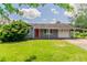 Charming single-story home with a well-maintained lawn and covered parking at 3217 Canterbury Trl, Rex, GA 30273