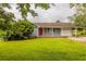 Charming single-story home with a well-maintained lawn and covered parking at 3217 Canterbury Trl, Rex, GA 30273