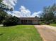 A single story home with a well manicured front yard and a driveway leading up to the garage and covered parking at 3217 Canterbury Trl, Rex, GA 30273
