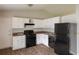 Kitchen featuring wooden flooring, white cabinets, and black appliances at 3217 Canterbury Trl, Rex, GA 30273