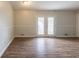 Empty living room featuring neutral paint, white trim, and wood-look flooring at 3217 Canterbury Trl, Rex, GA 30273