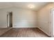 Empty living room featuring neutral paint, white trim, and wood-look flooring at 3217 Canterbury Trl, Rex, GA 30273