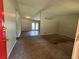 An open concept living room showcasing neutral walls and floors with a sliding glass door leading to the back yard at 3217 Canterbury Trl, Rex, GA 30273