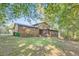 Spacious backyard with a screened-in porch, chain-link fence, and plenty of trees at 6118 Dana Ct, Lithonia, GA 30058