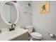 Half bathroom with a classic vanity, toilet, and light gray wall paint at 6118 Dana Ct, Lithonia, GA 30058