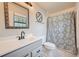 Bathroom featuring a patterned shower curtain, vanity with mirror, and modern fixtures at 6118 Dana Ct, Lithonia, GA 30058