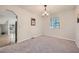 Dining room with neutral gray walls, modern chandelier, carpet, and a window at 6118 Dana Ct, Lithonia, GA 30058