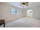 Large, neutral-toned living room filled with light from two large windows and carpeted floors at 6118 Dana Ct, Lithonia, GA 30058