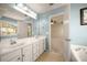 Dual sink bathroom with light-blue walls; view of a bedroom through an open door at 872 Misty View Ct, Lilburn, GA 30047