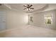 Spacious carpeted bedroom featuring a ceiling fan, and bright natural light from the two windows at 872 Misty View Ct, Lilburn, GA 30047