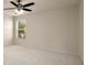 Neutral bedroom features a ceiling fan and ample natural light at 872 Misty View Ct, Lilburn, GA 30047