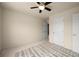 Carpeted bedroom with view to another room; neutral colors, white doors and trim, ceiling fan at 872 Misty View Ct, Lilburn, GA 30047