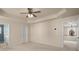 Bright bedroom with a ceiling fan; doorway leads to bathroom, and view to the second floor at 872 Misty View Ct, Lilburn, GA 30047