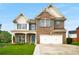 Charming brick two-story home with a well-manicured lawn and vibrant blue shutters at 872 Misty View Ct, Lilburn, GA 30047