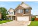 Beautiful two-story brick home featuring a spacious driveway and manicured front lawn at 872 Misty View Ct, Lilburn, GA 30047