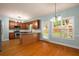 Bright kitchen featuring wood cabinets, granite countertops, stainless appliances, and hardwood floors at 872 Misty View Ct, Lilburn, GA 30047