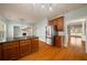 Open kitchen boasts granite counters, stainless steel refrigerator, and warm wood floors at 872 Misty View Ct, Lilburn, GA 30047