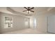 Spacious main bedroom with tray ceiling and many windows at 872 Misty View Ct, Lilburn, GA 30047