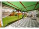 Enjoy a covered patio featuring a unique decorative floor, elegant sheer curtains, and outdoor seating at 872 Misty View Ct, Lilburn, GA 30047