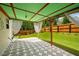Covered patio with geometric patterned concrete, wood columns, and a view of the backyard at 872 Misty View Ct, Lilburn, GA 30047
