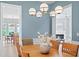 Dining room showcasing open concept to the living room and kitchen with light blue accent walls at 11945 Dancliff Trce, Alpharetta, GA 30009