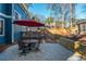 Backyard with patio seating, an umbrella, and a spacious, tiered yard at 1555 Steele Nw Dr, Atlanta, GA 30309