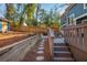 Spacious backyard with a tiered landscape design, stone walkway, and wooden retaining wall at 1555 Steele Nw Dr, Atlanta, GA 30309