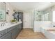 Spacious bathroom with double vanity, sleek cabinets, wood-look flooring, and a separate glass-enclosed shower at 1555 Steele Nw Dr, Atlanta, GA 30309