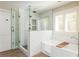Modern bathroom boasting a glass-enclosed shower, soaking tub and natural lighting at 1555 Steele Nw Dr, Atlanta, GA 30309