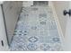 Close-up view of the decorative blue-patterned tile flooring in the bathroom at 1555 Steele Nw Dr, Atlanta, GA 30309